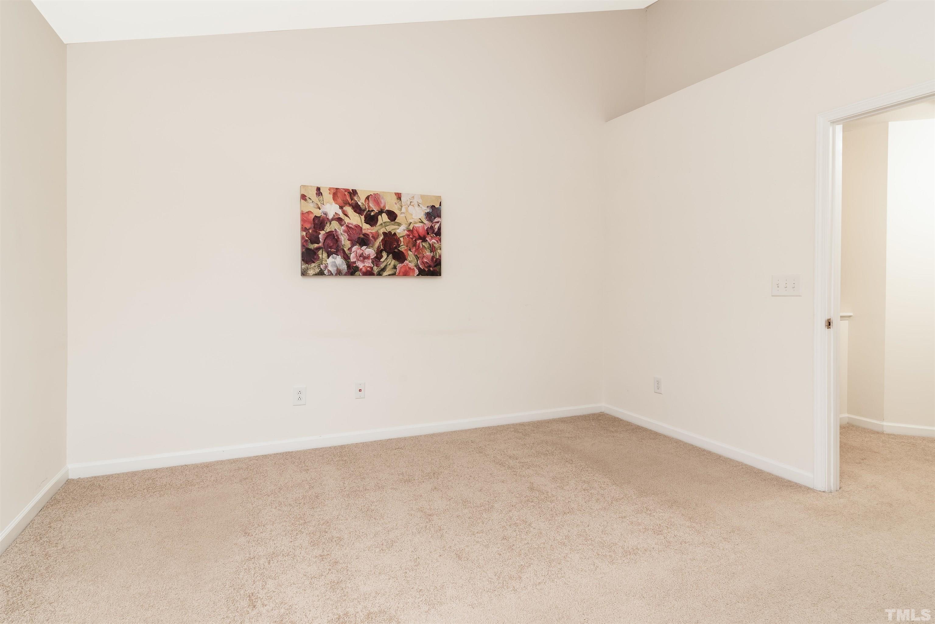 105 Graystar Road Apex, NC 27502 - Photo 27 of 35 an empty room with a painting on the wall