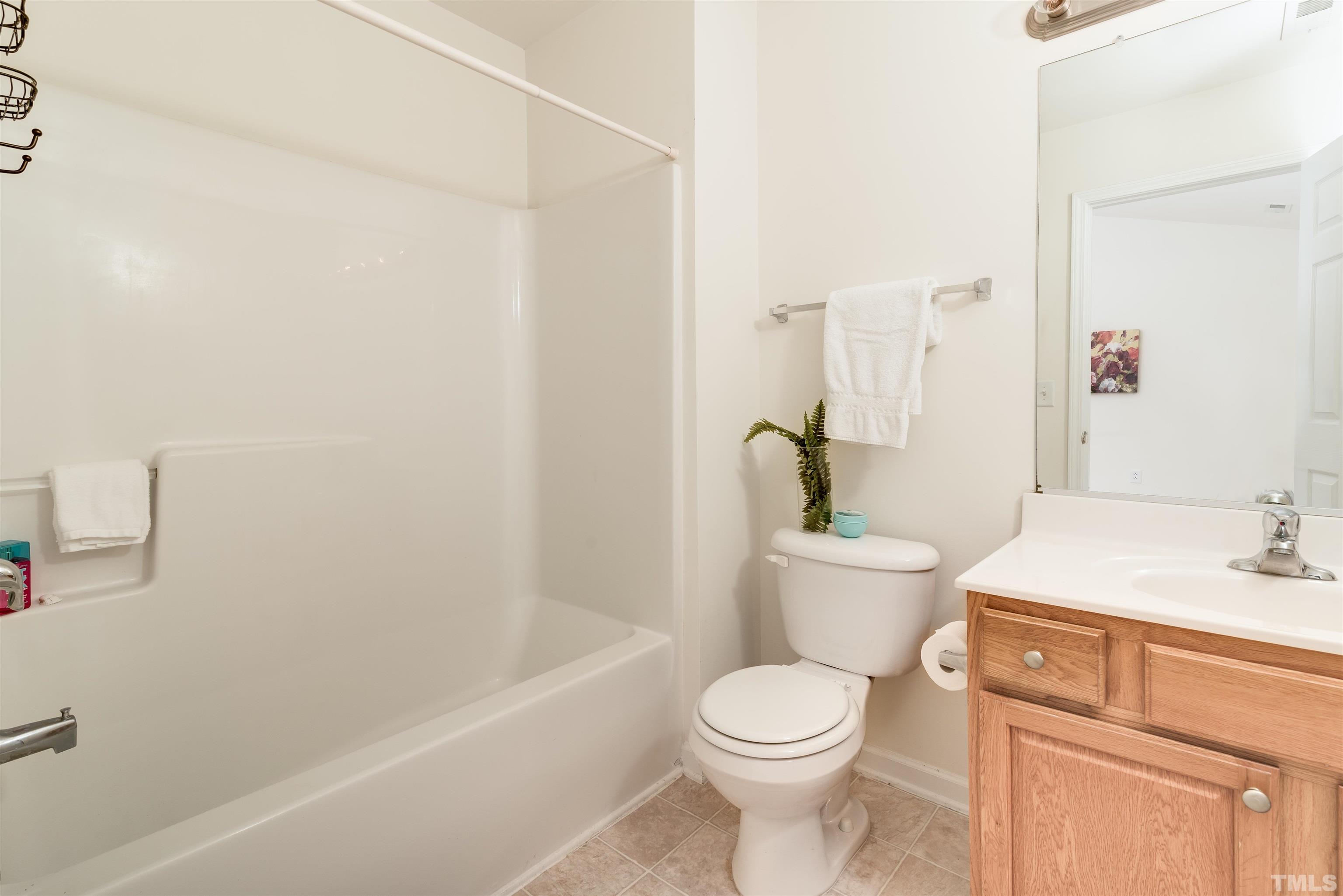 105 Graystar Road Apex, NC 27502 - Photo 28 of 35 a bathroom with a sink a toilet and shower