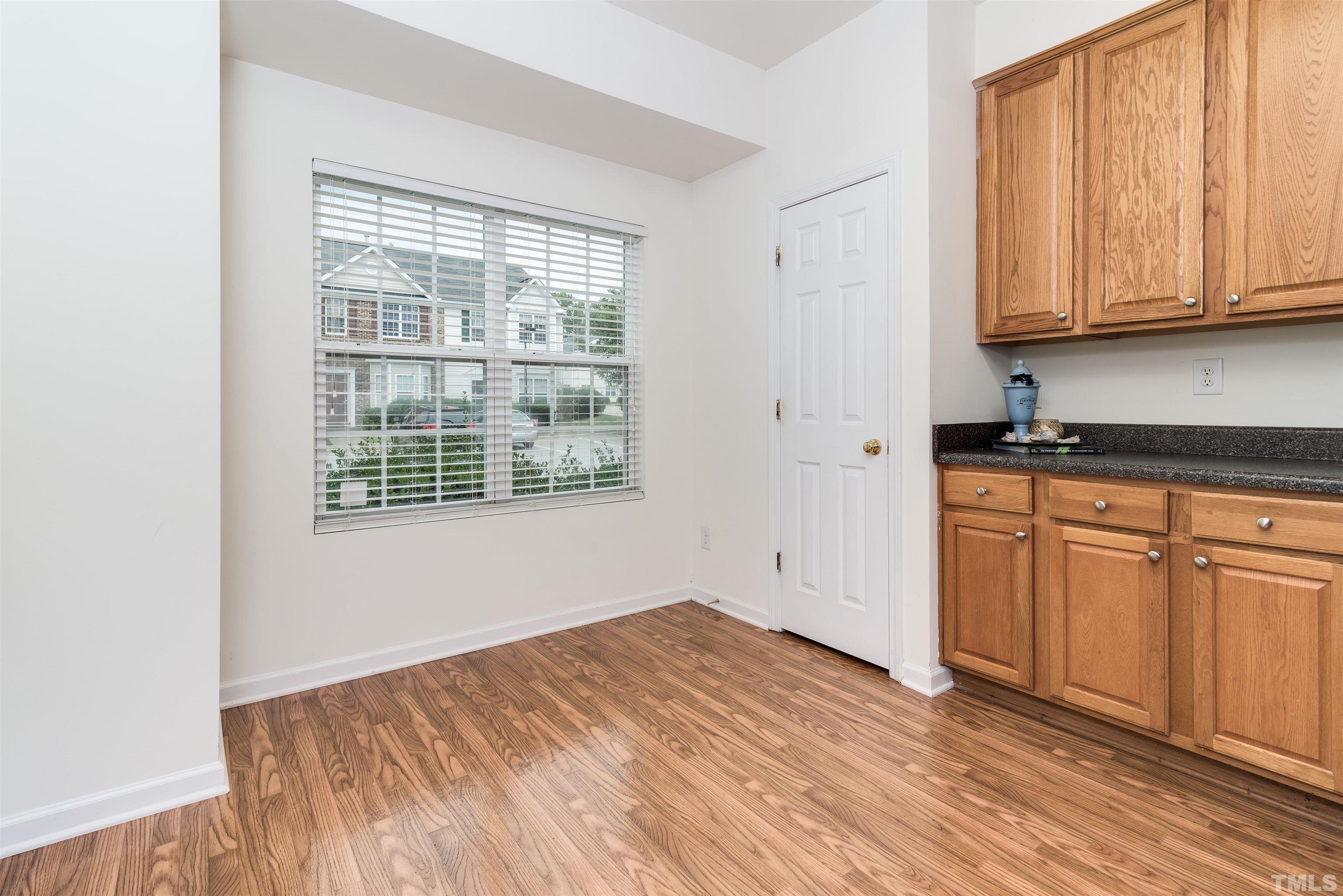 105 Graystar Road Apex, NC 27502 - Photo 3 of 35 a view of a kitchen with wooden floor and windows