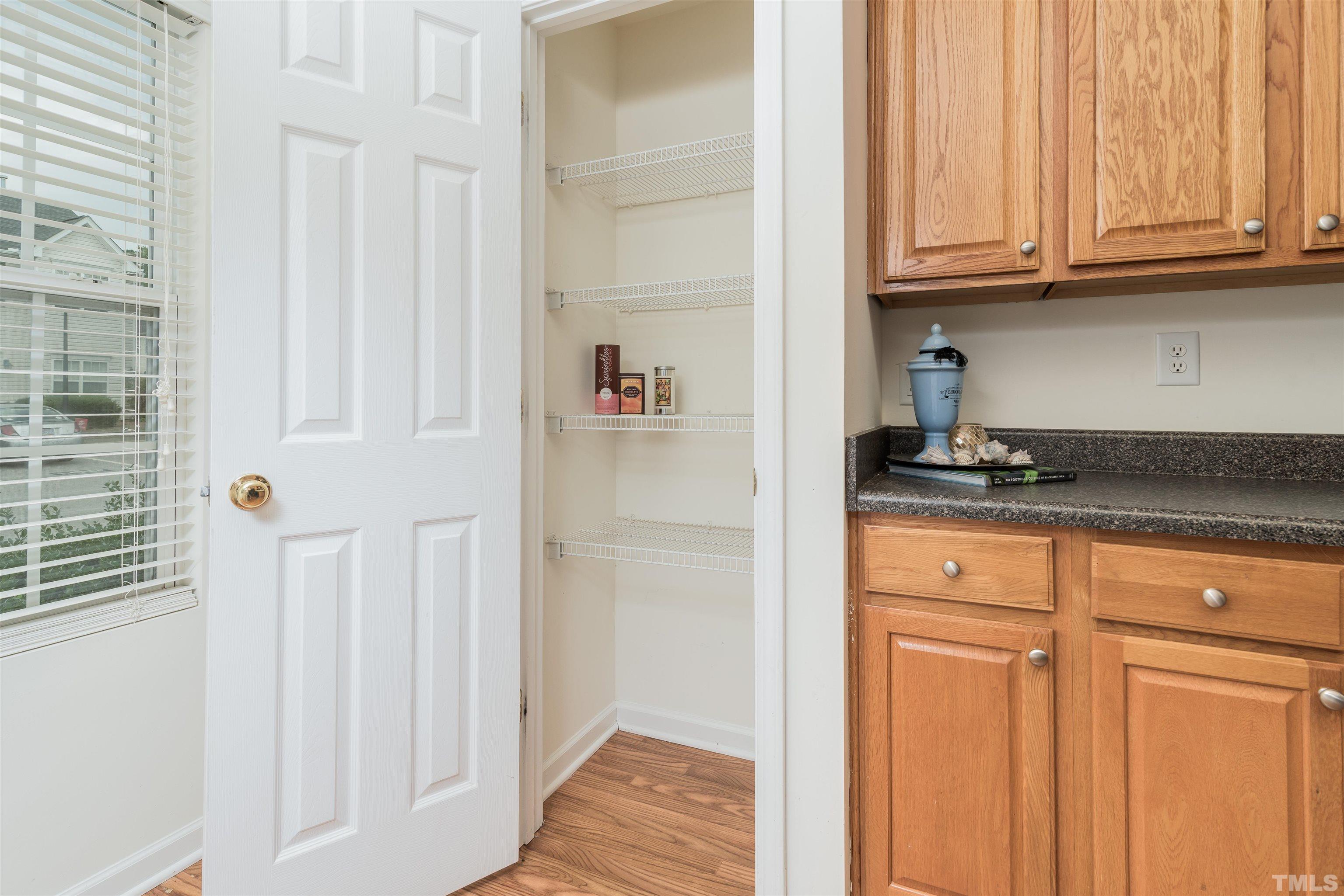 105 Graystar Road Apex, NC 27502 - Photo 4 of 35 a kitchen with granite countertop white cabinets and a refrigerator