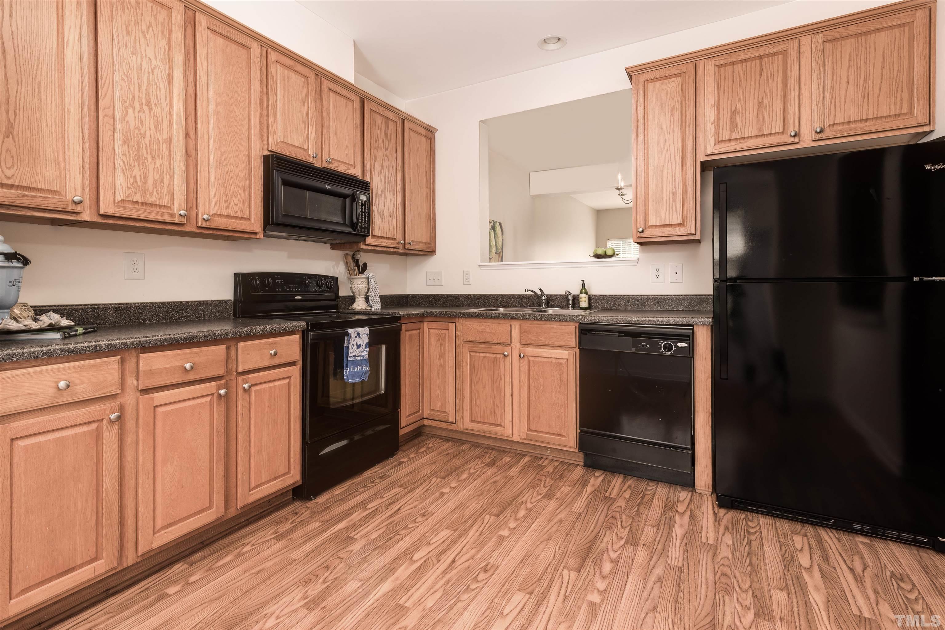 105 Graystar Road Apex, NC 27502 - Photo 5 of 35 a kitchen with stainless steel appliances granite countertop a refrigerator stove top oven and sink