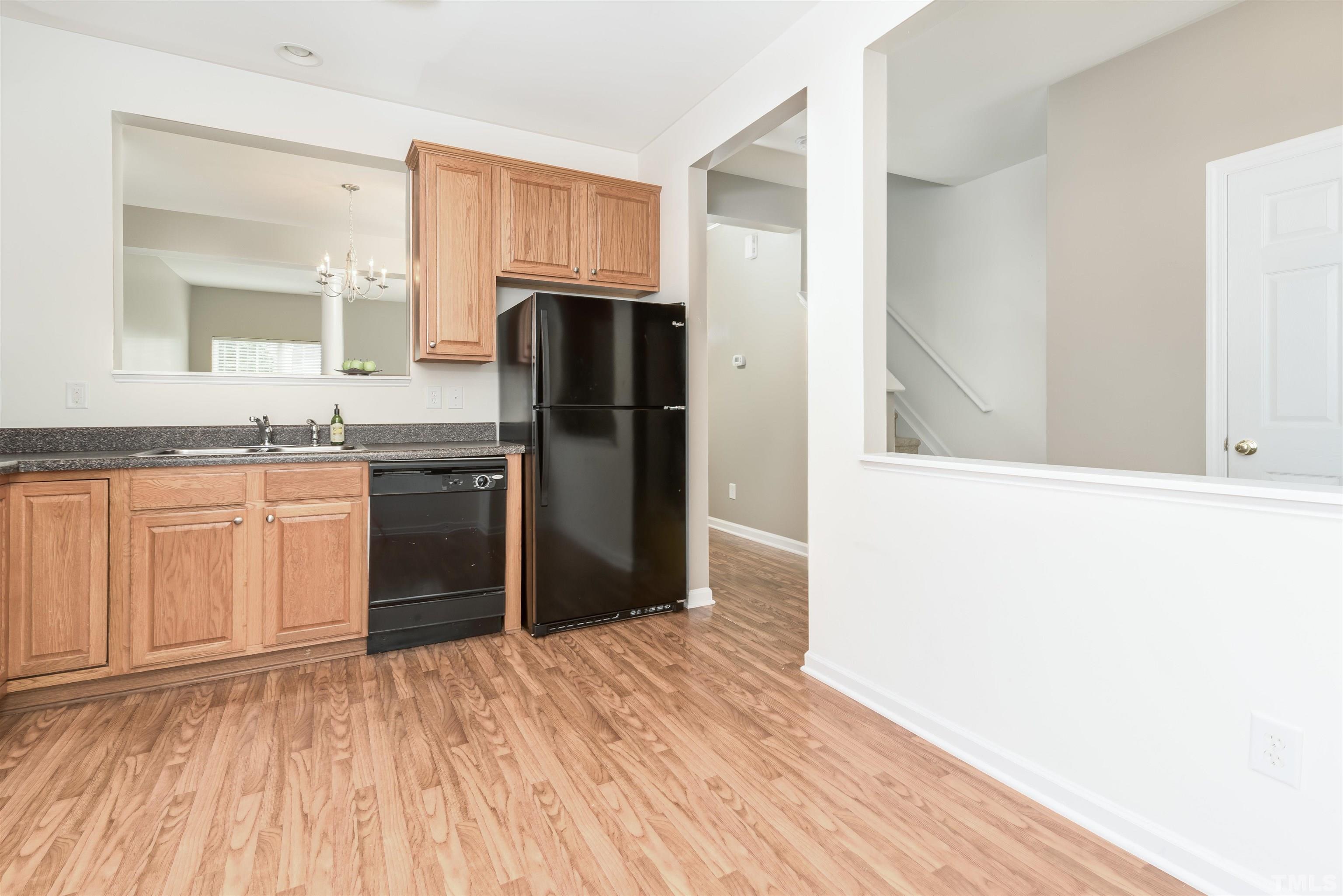 105 Graystar Road Apex, NC 27502 - Photo 6 of 35 a kitchen with a refrigerator and a sink