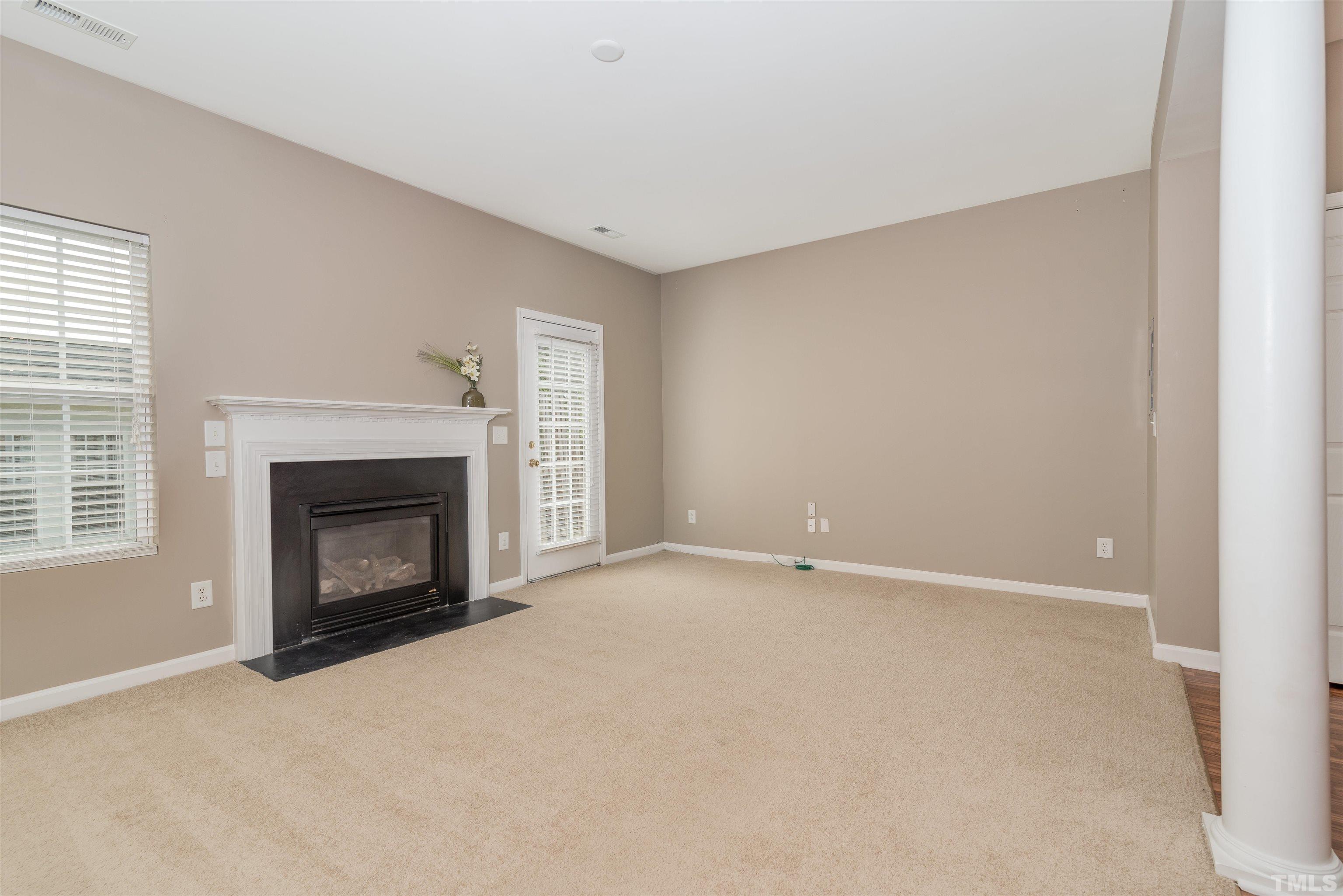 105 Graystar Road Apex, NC 27502 - Photo 8 of 35 a view of empty room with a fireplace