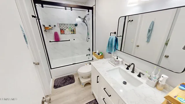 a bathroom with a sink and mirror with window