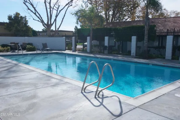 a swimming pool with outdoor seating and yard