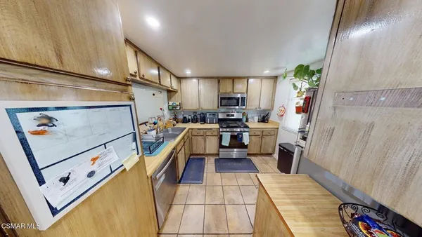 a kitchen with sink a refrigerator and a stove