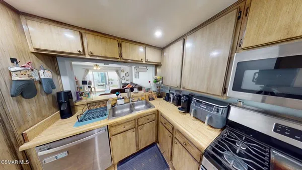 a kitchen with stainless steel appliances a sink stove and cabinets