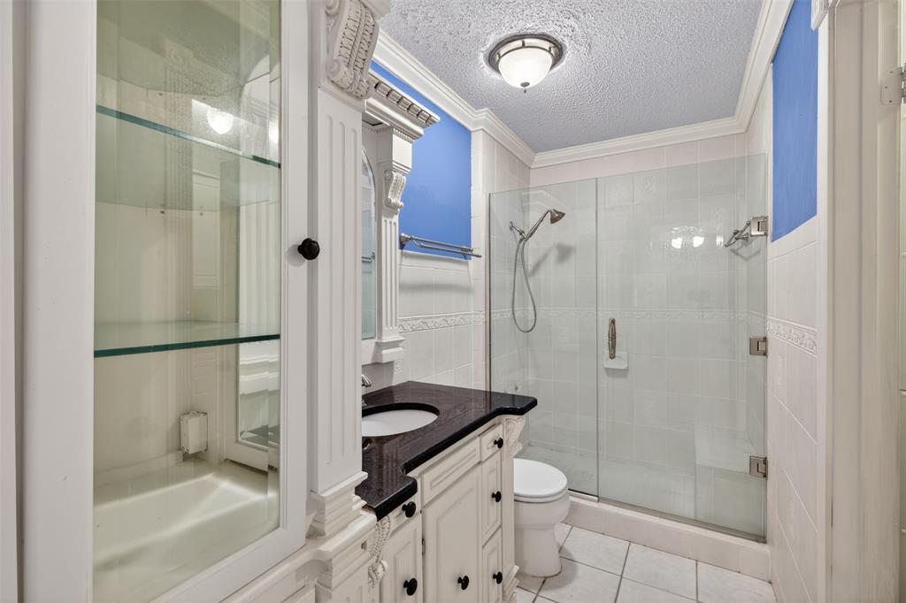 401 Cane Bend Drive Haughton, LA 71037 - Photo 12 of 27 a bathroom with a granite countertop sink a toilet and shower
