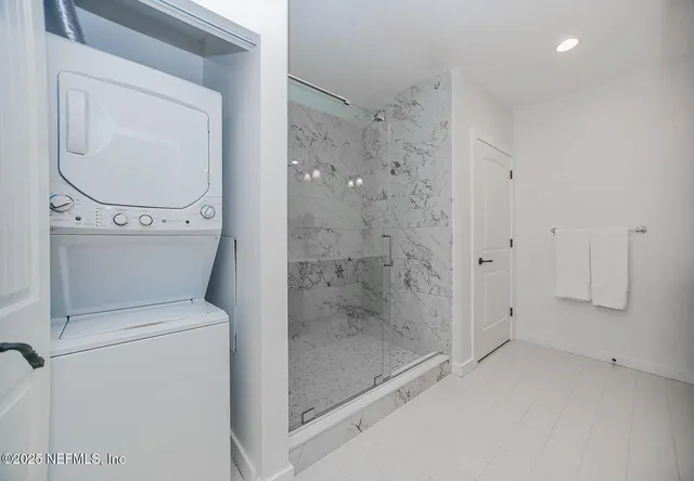 a bathroom with a granite countertop toilet a sink and a mirror