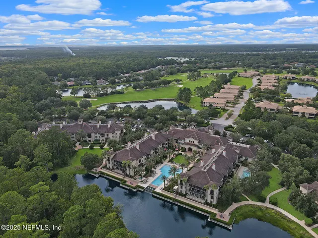 an aerial view of residential houses with outdoor space and river