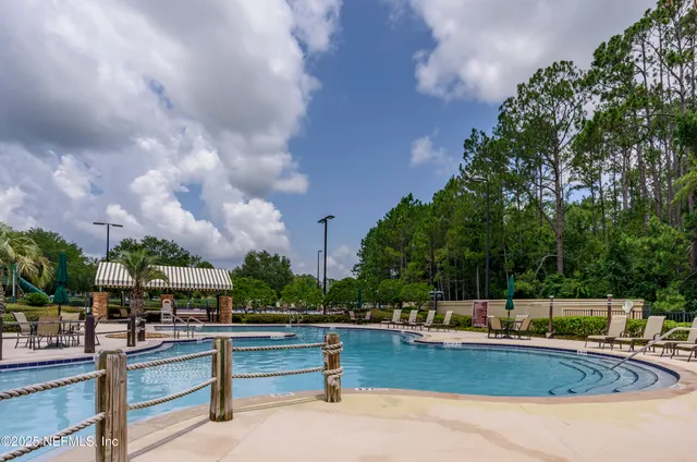 a view of swimming pool with outdoor seating and plants