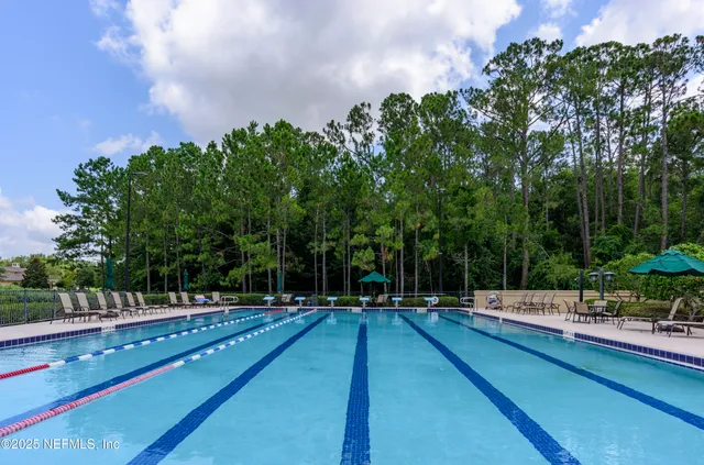 a swimming pool with outdoor seating and garden
