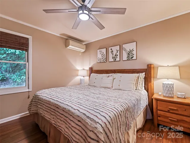 a backyard of a house with table and chairs under an umbrella