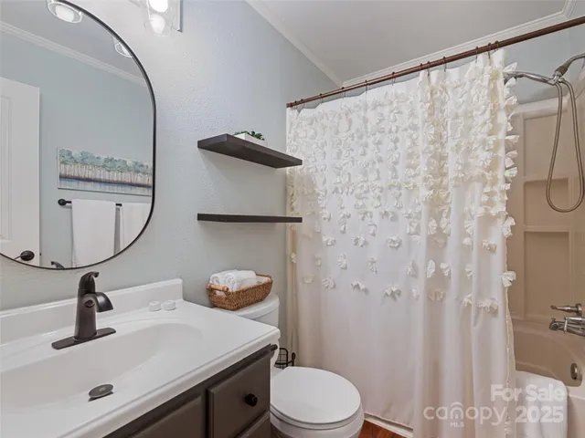 a view of a patio with table and chairs potted plants with wooden floor and fence