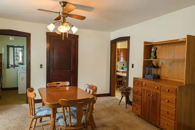 a view of a dining room with furniture and chandelier