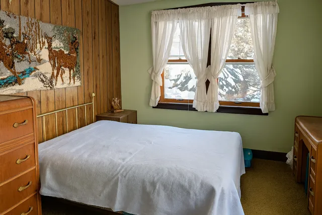 a bedroom with a bed and a window