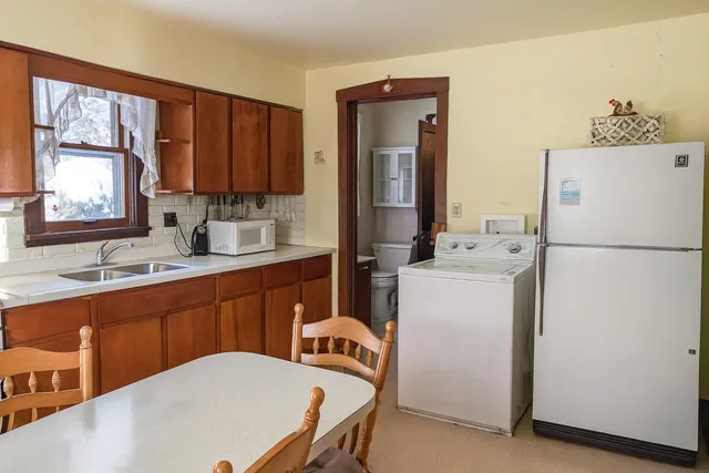 a kitchen with a refrigerator and a sink