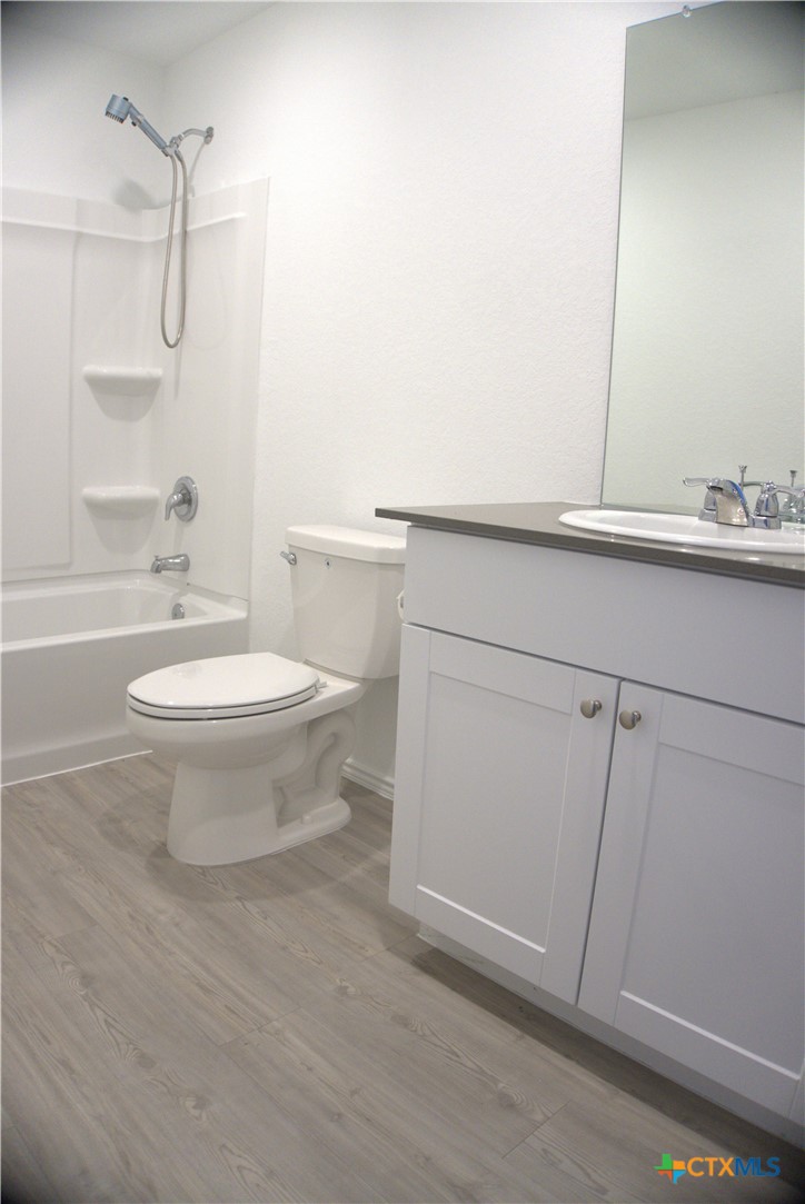 809 Riviera Court Seguin, TX 78155 - Photo 4 of 8 a bathroom with a toilet a sink and bathtub
