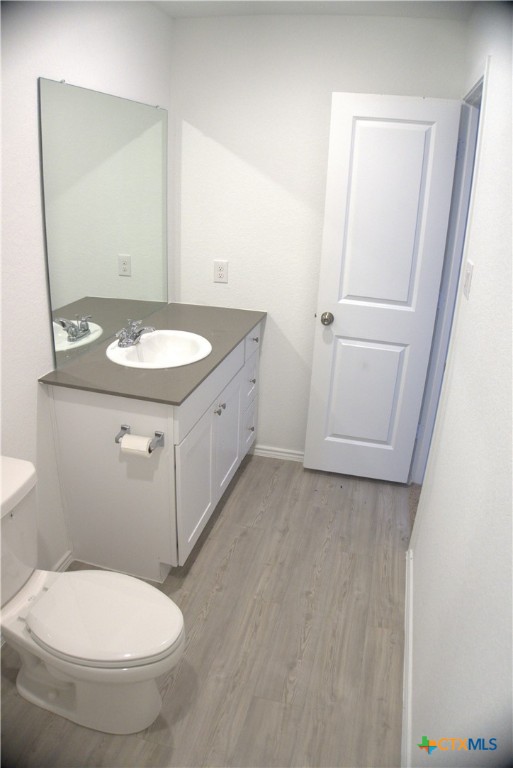 809 Riviera Court Seguin, TX 78155 - Photo 5 of 8 a bathroom with a granite countertop sink toilet and mirror