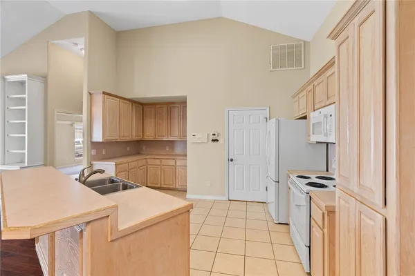 a kitchen that has a cabinets and a stove top oven