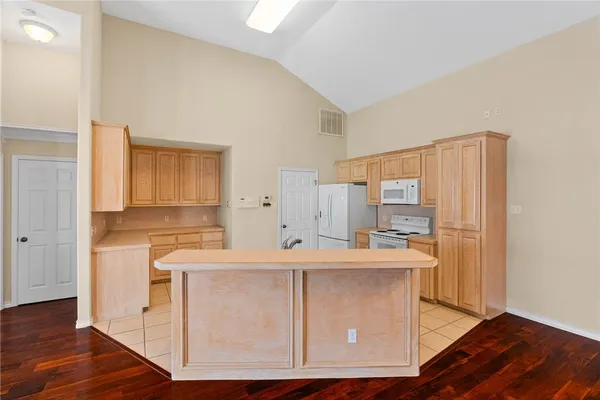 a kitchen with a sink cabinets appliances and a window