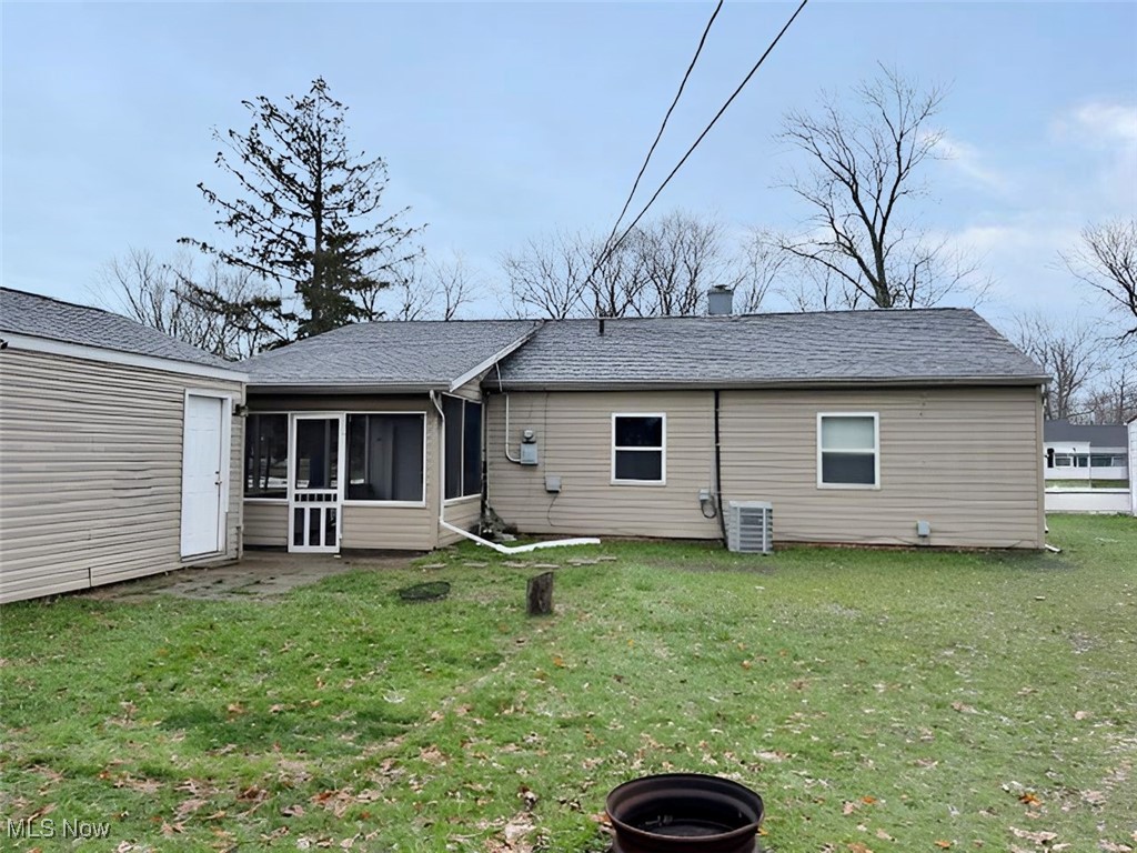 4842 Marigold Road Mentor, OH 44060 - Photo 3 of 13 Rear view of property featuring a lawn, a sunroom, and central AC unit