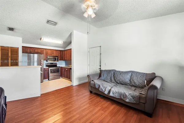 a living room with furniture and wooden floor