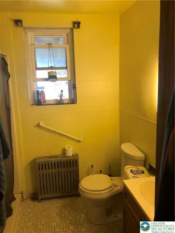 a bathroom with a toilet and a sink