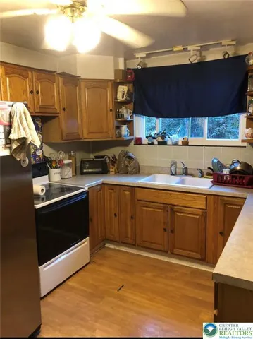 a kitchen with stainless steel appliances granite countertop a sink stove and cabinets