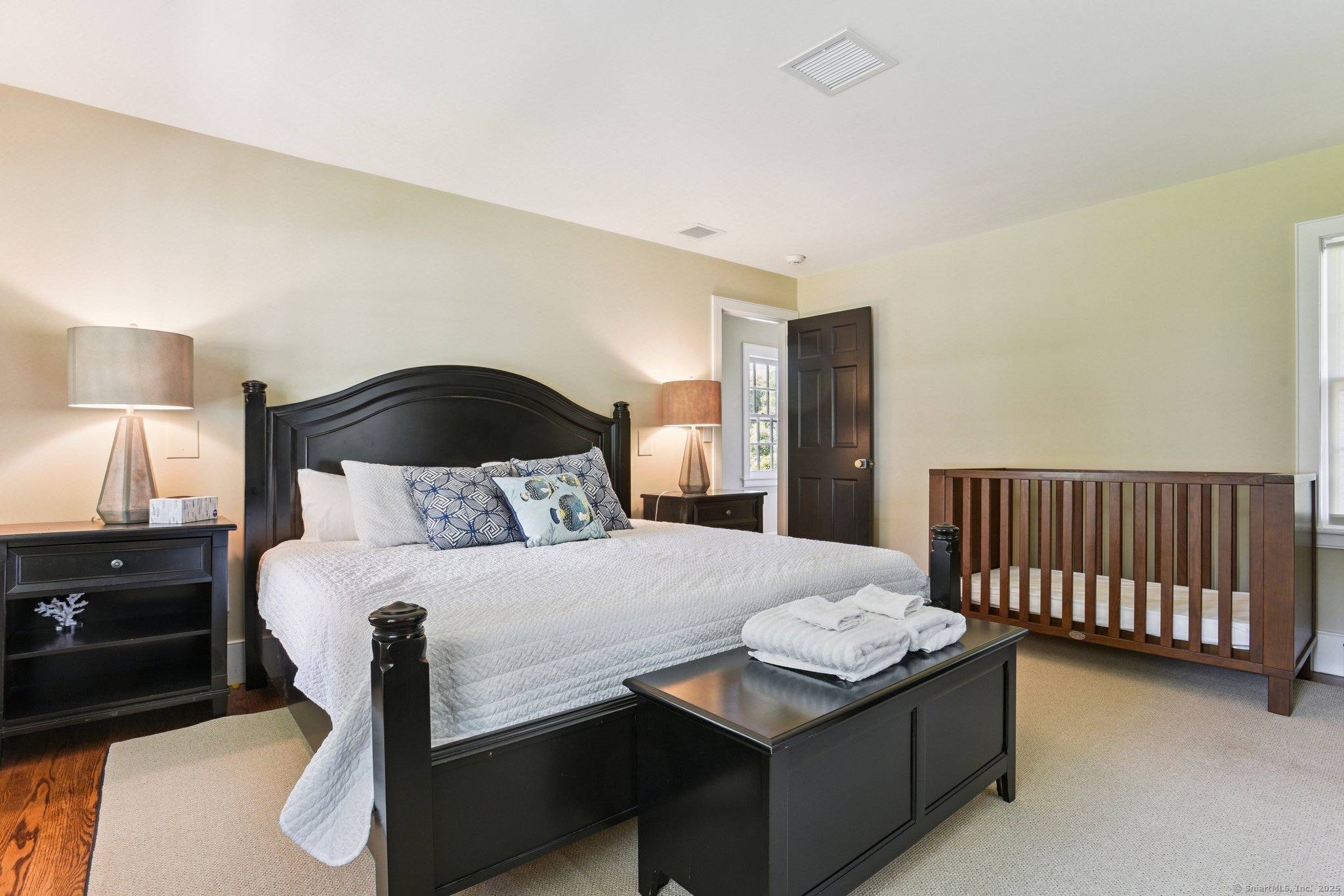 455 Stonington Road Stonington, CT 06378 - Photo 23 of 39 a bedroom with a bed and a lamp