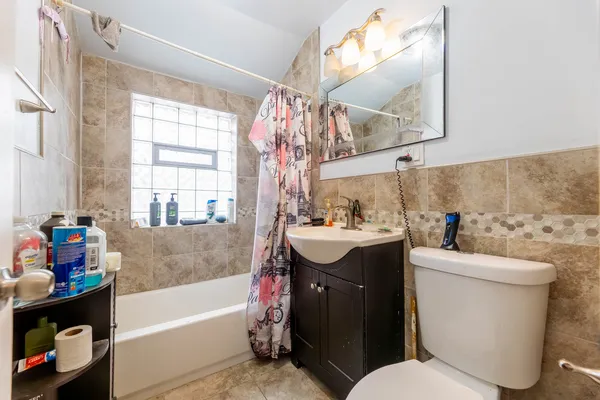 a bathroom with a sink mirror toilet and bathtub