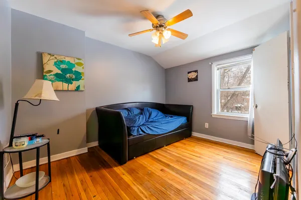 a bedroom with a bed and a chandelier