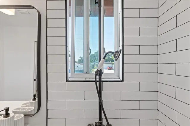 a bathroom with a shower and a mirror