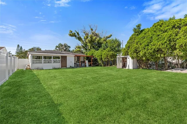 a view of a house with a backyard