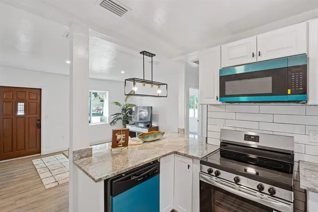 a kitchen with a stove and a microwave
