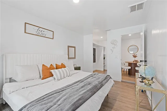 a bedroom with a large bed and a chandelier