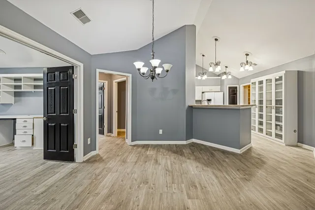 a view of a room with cabinet and wooden floor