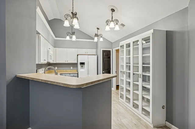 a kitchen with kitchen island a sink stainless steel appliances and cabinets