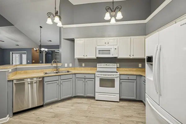 a kitchen with stainless steel appliances a sink stove and refrigerator