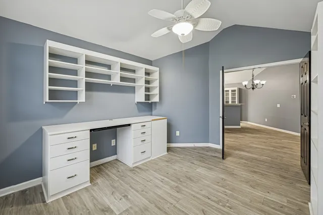 a view of a bedroom with wooden floor and cabinet