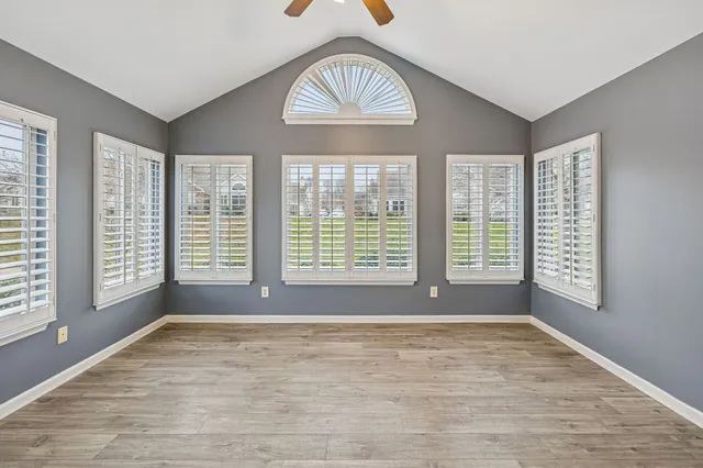 a view of an empty room with windows