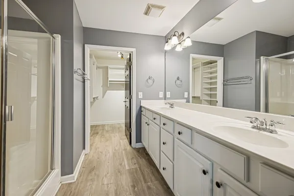 a spacious bathroom with a double vanity sink and mirror