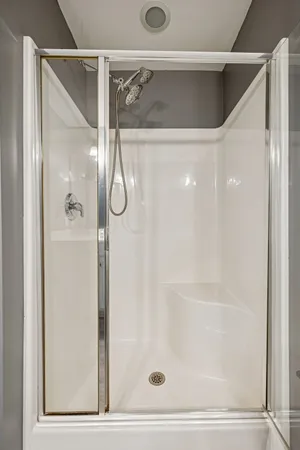 a bathroom with a glass shower door