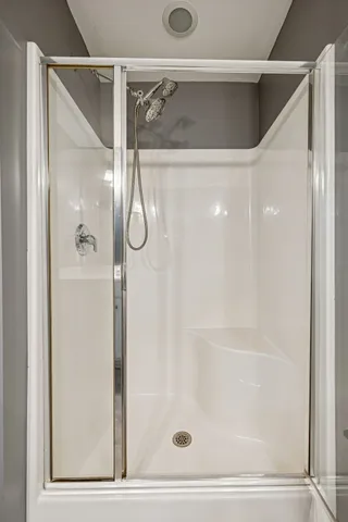 a bathroom with a glass shower door