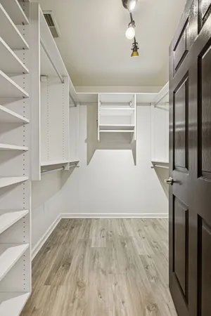 a view of a livingroom with wooden floor and staircase