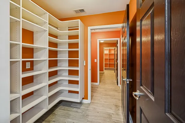 a view of walk in closet with empty racks