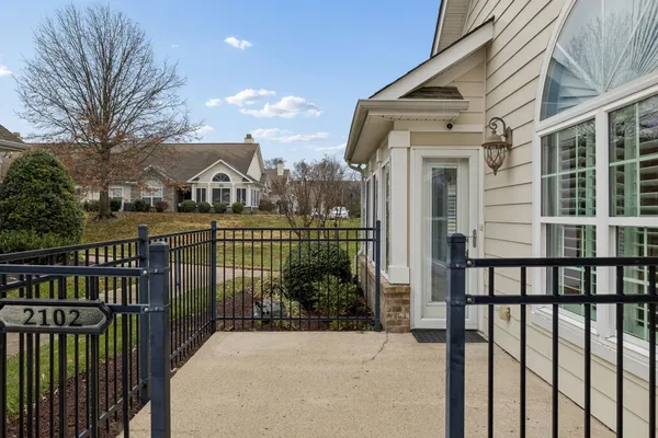 a view of a brick house with a large window and plants