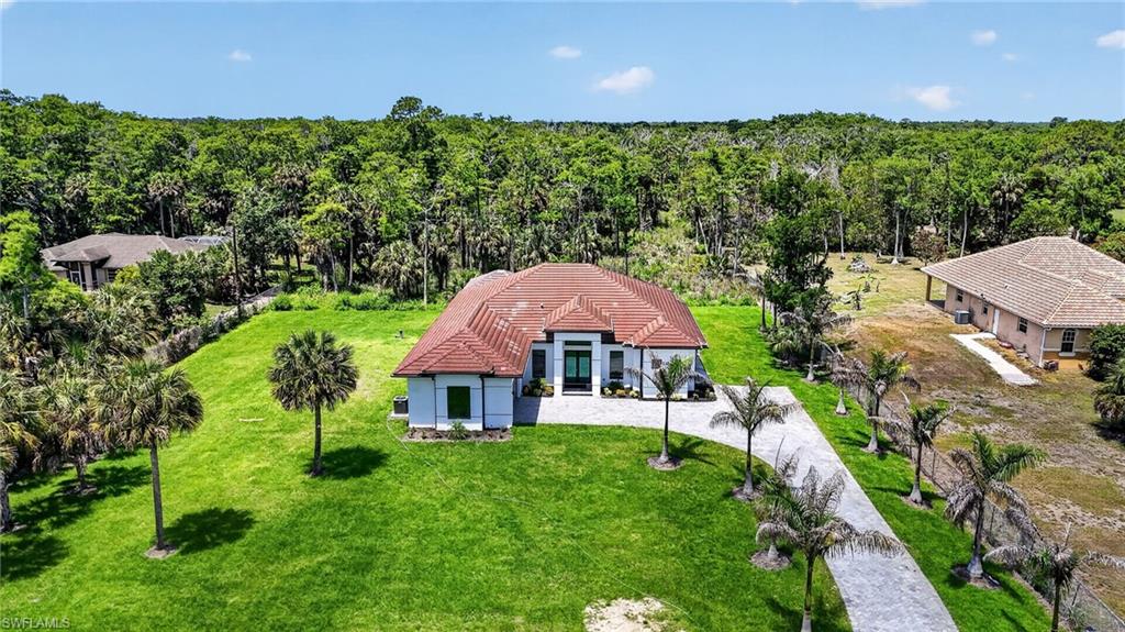 563 15th Street Northwest Naples, FL 34120 - Photo 1 of 22 a aerial view of a house with swimming pool and green space
