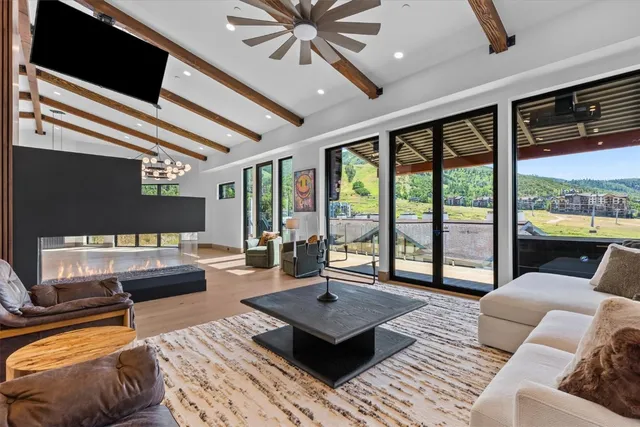 a living room with furniture and a floor to ceiling window
