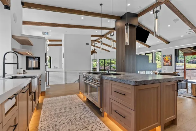 a living room with furniture and a floor to ceiling window